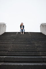 Image showing Business woman, sitting and stairs in portrait, low angle and mockup space in city, metro and relax on break. Young entrepreneur, urban cbd and freedom on steps with corporate fashion, pride or smile