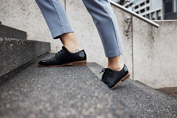 Image showing Stairs, city person and legs walking, travel or on morning journey, outdoor commute or on urban trip. Concrete steps, ground and closeup shoes, feet or commuter climbing staircase of building