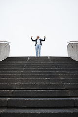 Image showing Business woman, stairs and celebration for success, goal or winning in finance career, investment or stock market. Young entrepreneur, winner and fist in air for achievement, pride or lottery in city