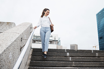 Image showing Woman, worker and walking on city building steps happy, smile and cheerful while traveling. Travel, walk and female person smile for commute, leaving and enjoying solo trip in New York outdoor