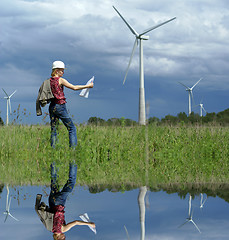 Image showing Woman engineer or architect with white safety hat and wind turbi