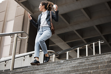 Image showing Stairs, city and business woman walk, travel or using phone, schedule or check time on outdoor journey. Cellphone, work coffee break and professional person leave office building on staircase steps
