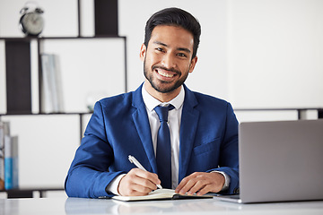 Image showing Portrait, business man and writing in notebook with laptop for administration in law firm. Face of happy asian lawyer, attorney and planning in book while working on computer for legal management