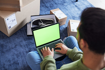 Image showing Ecommerce, man with computer, green screen and box on carpet, shoes and delivery service on digital app. Sale, discount and online shopping on fashion retail brand website, internet search on laptop.