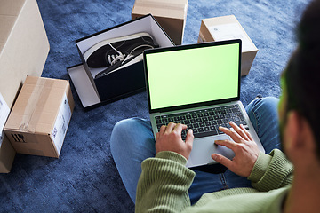 Image showing Green screen, man with laptop, online shopping and box on floor, shoes and delivery service on digital app. Sale, discount and ecommerce on fashion retail brand website, internet search on computer.