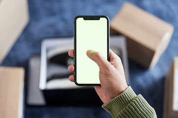 Image showing Phone green screen, boxes and person hands online shopping, scroll ecommerce site or check omnichannel website. Courier service, mail shipping or home customer with cellphone, delivery app or package