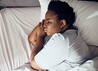 Image showing Stress, thinking or black woman in bed with insomnia or anxiety from sleeping problem in bedroom. Wake up, burnout or tired African girl with mistake, loss or depression from emotional grief at home