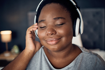Image showing Crying, happy and black woman with headphones for music, sound or audio. Tears, radio and plus size African person listening, hearing and streaming podcast for peace or relax in home bedroom at night