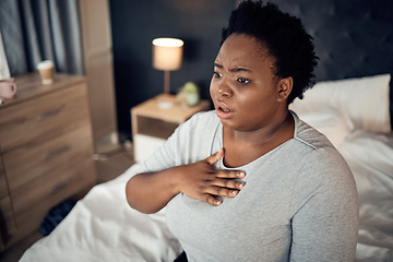 Image showing Fear, bedroom and black woman with an anxiety attack or pain in chest from stress. Scary, health and an African girl on a bed with panic, depression or a mental health, mistake or sick for psychology
