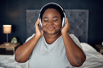 Image showing Crying, smile and black woman with headphones for music, sound or audio. Tears, radio and plus size African person listening, hearing and streaming podcast for peace or relax in home bedroom at night