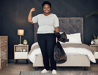 Image showing Black woman, garbage bag and champion, success in cleaning and bedroom with hygiene in portrait. Strong female cleaner, winner at housekeeping with smile, morning routine and maintenance at home