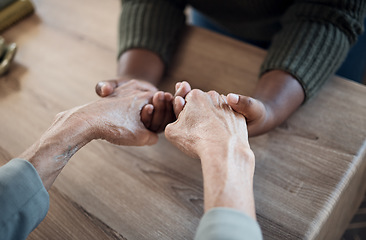 Image showing Holding hands, support and praying, people and counseling top view with psychology and therapy together. Kindness, respect and worship, trust and help, wellness with communication, comfort and care