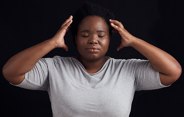 Image showing Frustrated black woman, stress and anxiety in studio with fear of crazy memory, trauma or noise in mind on dark background. Face of confused model in burnout, brain fog or depression of mental health