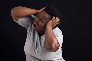 Image showing Frustrated, scream and black woman with anxiety, mental health and lose control on a dark studio background. Emotion, screaming or model with depression, shouting and pain with burnout or expression