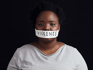 Image showing Portrait, censorship and a black woman in protest of domestic violence on a dark background. Freedom, gender equality or empowerment with a serious young female person in studio for human rights