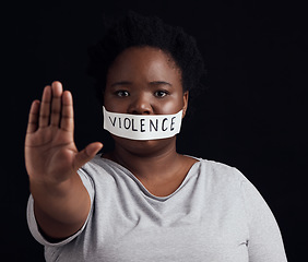 Image showing Portrait, hand and a black woman in protest of domestic violence on a dark background. Freedom, equality or empowerment with the palm of a serious young person in studio for gender discrimination