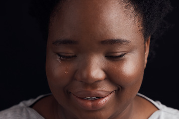 Image showing Crying, sad and a black woman on a studio background with depression, fear or mental health. Studio, face and an African girl or person with tears, frustrated or fail from a mistake on a backdrop