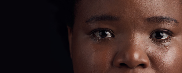 Image showing Black woman, eyes and mental health, crying with depression and crisis with abuse on dark background. Sad, portrait and anxiety, depressed female person with face on banner and grief in studio