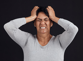 Image showing Anger, anxiety and senior woman screaming, depression and mental health issue on a dark studio background. Person, emotion or model shouting, frustrated and angry with bipolar, moody and lose control