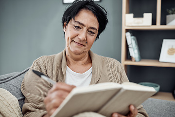 Image showing Smile, relax and an old woman writing in her journal while sitting in the living room of her retirement home. Notebook, pen and a happy senior female pensioner on a sofa, taking notes in a diary