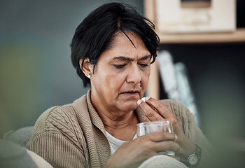 Image showing Depression, drinking water or old woman in home to take pills, vitamins or supplements as medicine. Medical, sick or lonely senior person taking drugs or medication tablets for fatigue or anxiety