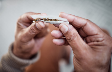 Image showing Marijuana, cannabis or hands rolling weed joint for calm peace to relax or help reduce stress or anxiety. Smoker, smoking cbd or closeup of person with hemp blunt for mental health benefits on 420