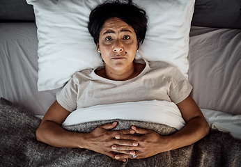 Image showing Insomnia, portrait and senior woman in bed from above with menopause, anxiety or stress in her home. Top view, face and elderly female in a bedroom with depression, trauma or mental health crisis