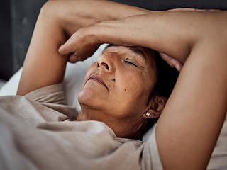 Image showing Sleeping, headache and senior woman in home bedroom with fatigue, tired or exhausted. Depression, insomnia and elderly person in bed with pain, stress and problem, anxiety or crisis in retirement