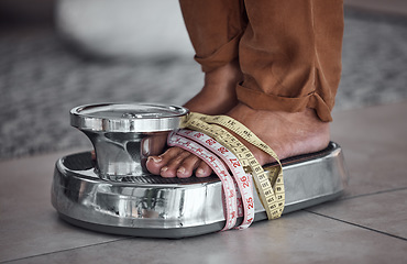 Image showing Feet, anorexia and person on scale with tape measure to check body to lose weight with stress. Balance, foot and results of diet, unhealthy obsession and eating disorder at home, counting calories