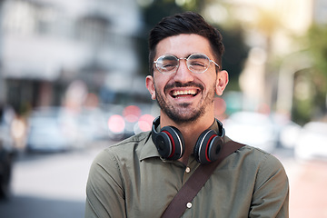 Image showing Travel, city and portrait of a man outdoor on a road with a smile, glasses and headphones. Happy student or business person on urban street with freedom and pride for creative internship in Miami