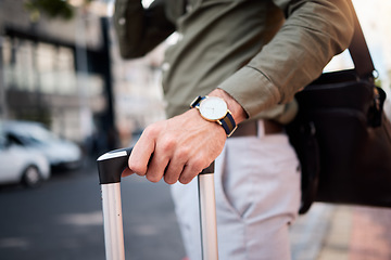 Image showing Suitcase, man hand and city with business person, watch and professional on urban street. Luggage, work travel and commute on a road with carry on bag for career and businessman holiday in town