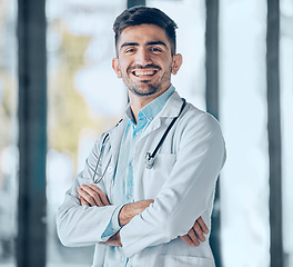 Image showing Happy man, doctor and professional with arms crossed for healthcare, advice or career ambition at the hospital. Portrait of male person, surgeon or medical expert smile for healthy wellness at clinic