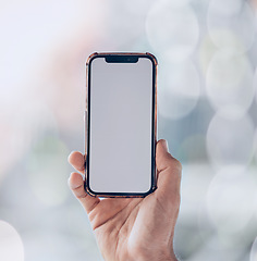 Image showing Person, hands and phone mockup screen for advertising, social media app or networking space on a bokeh background. Closeup of mobile smartphone display for advertisement, logo branding or marketing