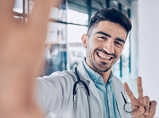 Image showing Happy, selfie and man doctor peace sign for social media for healthcare, medical and hospital work. Job, male professional and surgeon worker portrait with picture and smile for internet photo