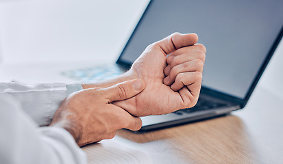 Image showing Man, hands and wrist pain from injury, accident or carpal tunnel syndrome on desk at office. Closeup of male person or employee with bad arm ache, sore muscle or tension and overworked at workplace