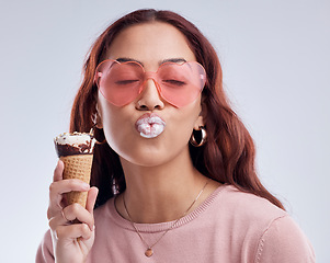 Image showing Kiss, ice cream and face of woman with sunglasses in studio with dessert, snack and sweet treats. Kissing emoji, fashion and female person with gelato cone in trendy accessories, style and cosmetics