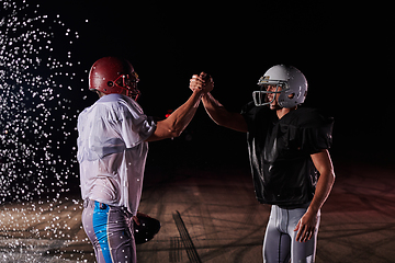 Image showing Two american football players face to face in silhouette shadow on white background