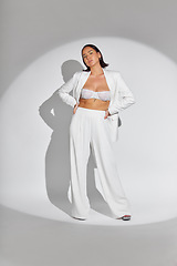 Image showing Fashion, spotlight and portrait of a woman with a stylish, glamour and fancy outfit in studio. Luxury, beautiful and full body of an Asian female model with elegant suit isolated by white background.
