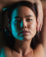 Image showing Neon, beauty and studio portrait of Asian woman with natural cosmetics, shadow or blue skincare light, glow or shine. Creative lighting, self love or face of person with makeup on dark background