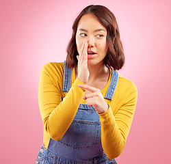 Image showing Whisper, hand pointing and asian woman in studio with gossip, drama or hush news on pink background. Secret, did you know and Japanese female with emoji for confidential, privacy or coming soon promo