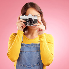 Image showing Photographer woman, retro camera and studio for shooting, memory or paparazzi job by pink background. Journalist girl, photoshoot and lens for newspaper, gossip magazine or content creator for blog