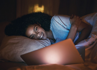 Image showing Laptop, happy and woman on bed at night for website, online social media and relax in home. Bedroom, computer and person streaming movie, internet film and video on technology with insomnia in house.