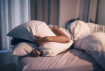 Image showing Bed, insomnia and woman with pillow on face, tired and frustrated with stress, nightmare or dream. Fatigue, sleep problem and exhausted girl in bedroom with fear, scared at night and crisis in home.