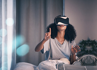 Image showing Woman, bed and vr glasses in night, home and online in metaverse, matrix and press with finger for choice. Girl, augmented reality games and vision for 3d user experience, dark bedroom and apartment
