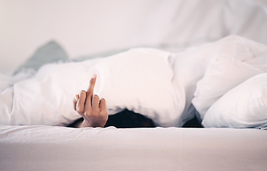 Image showing Angry, hand and person with insomnia in bed with a middle finger for morning or waking up, sleeping in bedroom and at home. Hand, show a curse sign and frustrated with sleep problem at night