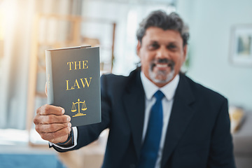 Image showing Law, book and portrait of a man or lawyer with a book, constitution or research with legal books, study and knowledge. Attorney, judge or businessman with advice in a office, court or consultant