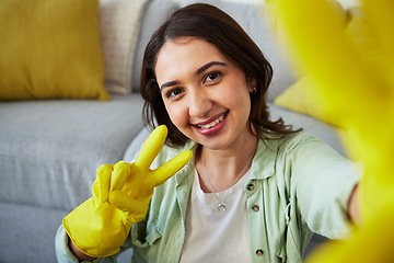 Image showing Woman, selfie and peace for cleaning home, portrait or smile in gloves, social media or sign language. Happy influencer girl, photography and profile picture with emoji to stop bacteria in apartment