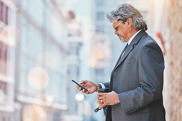 Image showing Senior, business man and cellphone in city, travel and commute, bokeh and communication outdoor. Mexican male executive, CEO using phone to chat on journey to work and urban street with mockup space