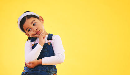 Image showing Confused, thinking and kid in doubt, decision and studio isolated on yellow background mockup space. Question, idea and girl child trying to remember memory, solution or choice, why and brainstorming