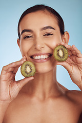 Image showing Beauty portrait, kiwi and woman for skincare, cosmetics and natural product, facial health and vitamin c. Face of young happy person or model, green fruits and dermatology on studio, blue background